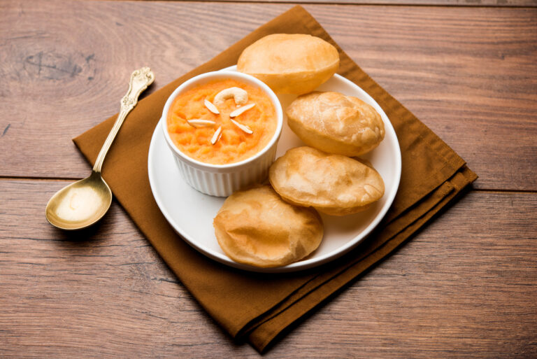 Sooji Halwa Puri or Shira Poori breakfast, served in a plate and bowl